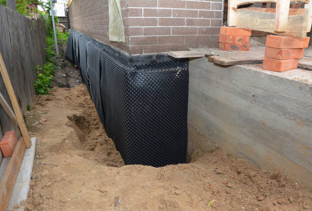 Happy homeowners after waterproofing job in Portage
